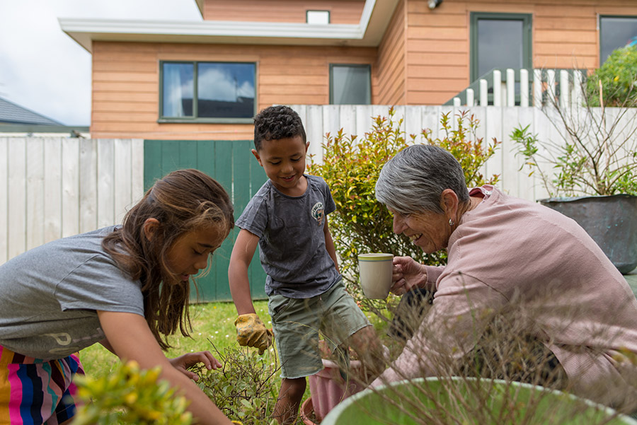 Grandmother gardening with grandchildren Grandmother gardening with grandchildren
