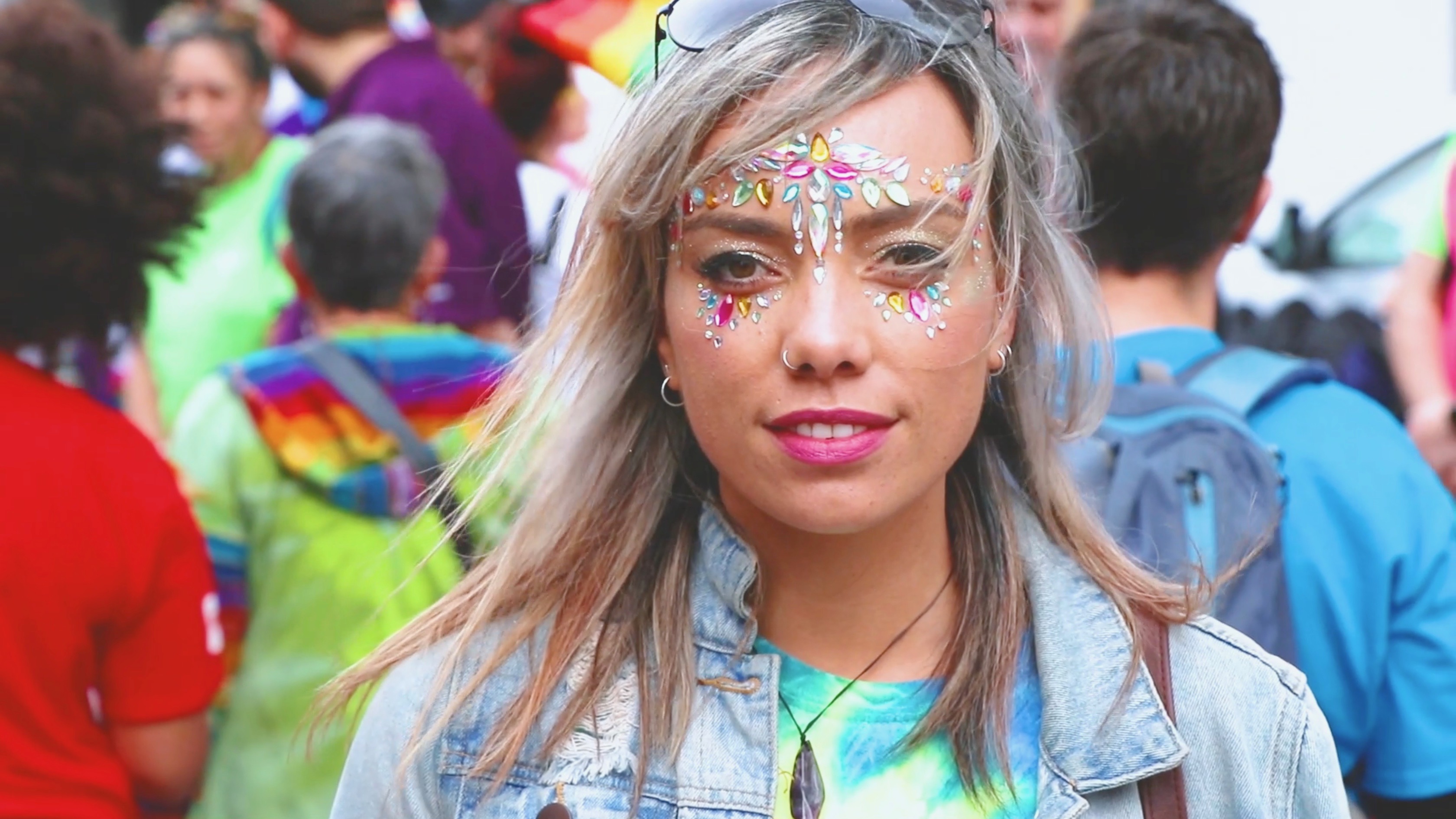 Woman wearing face paint at Pride Parade.
