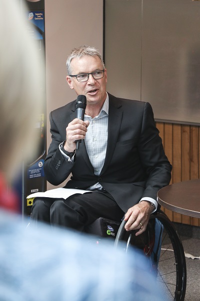 Ben Lucas resized Man in wheelchair speaking into a microphone