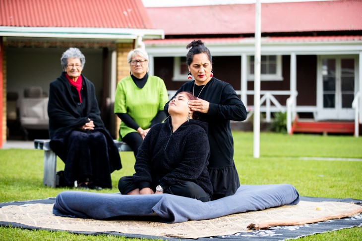 Rongoā practitioner providing treatment outdoors